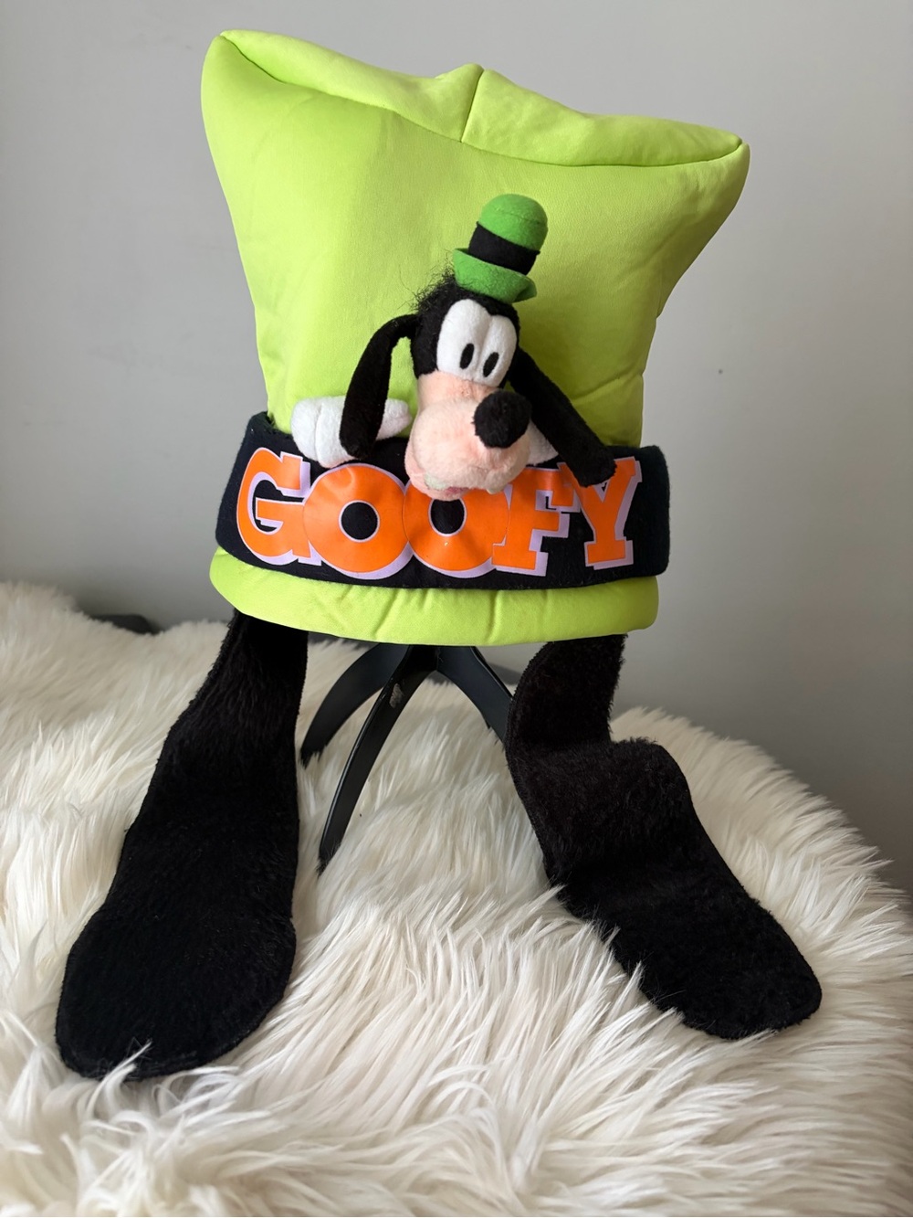 Disney Parks green Goofy hat with long, fuzzy black ears and a plush Goofy